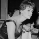Sophia Loren leans over a table